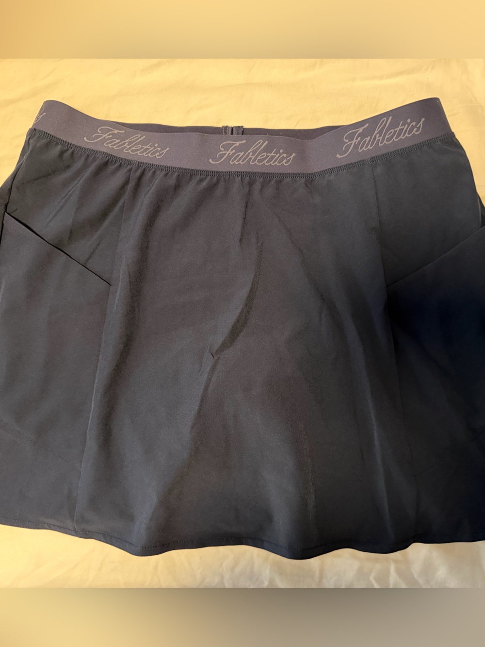 Fabletics, navy blue tennis skirt with pockets and built in shorts